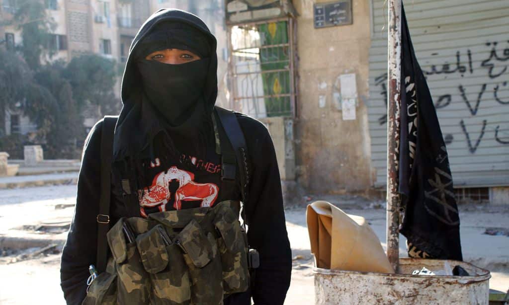 A member of jihadist group Al-Nusra Front stands in a street of the northern Syrian city of Aleppo on January 11, 2014. (AAP)