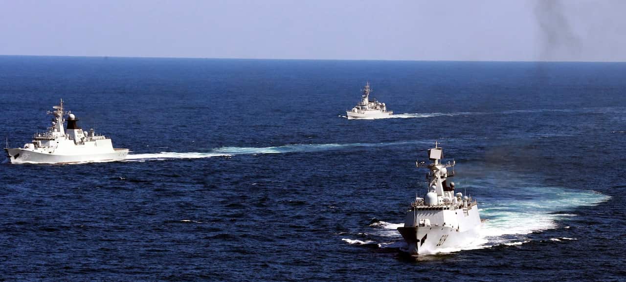 Ships sailing in blue waters.