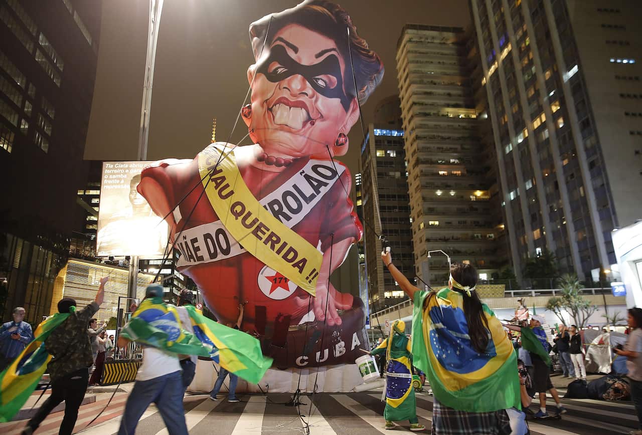 Anti-government demonstrators set up a large inflatable doll in the likeness of Brazil's President Dilma Rousseff in Sao Paolo