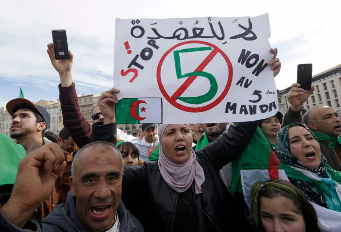 A demonstrator holds up a sign that reads, 'no to a 5th term' during a protest to denounce President Abdelaziz Bouteflika's bid for a fifth term in southern France (AAP)