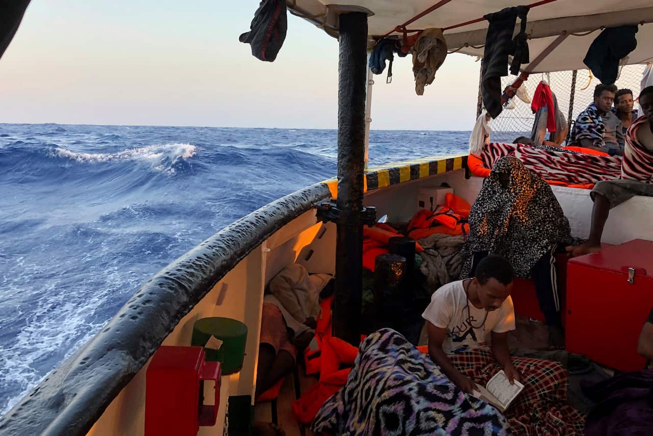 A migrant reads verses of the Quran aboard the Open Arms Spanish humanitarian boat (AAP)
