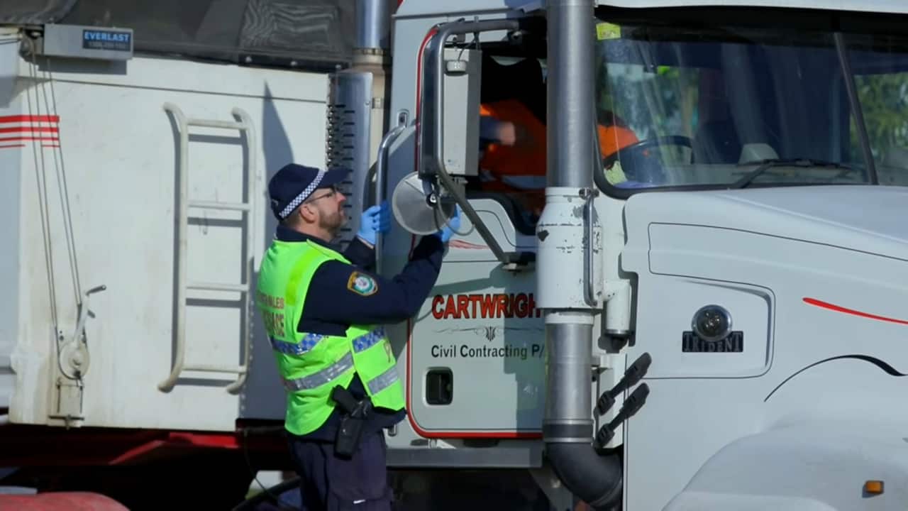 A truck driver is stopped at the NSW-Victoria border