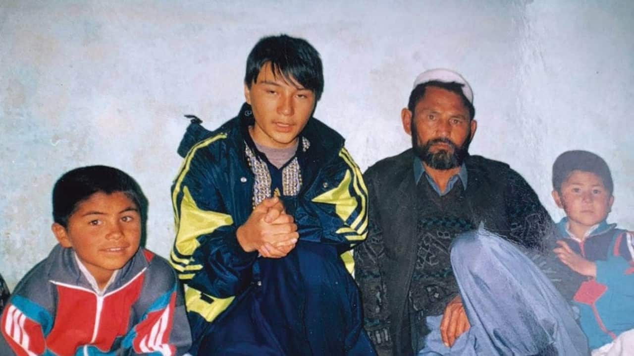 Abbas Nazari (right) with his brothers and father in the late 1990s, before the family would flee Afghanistan.