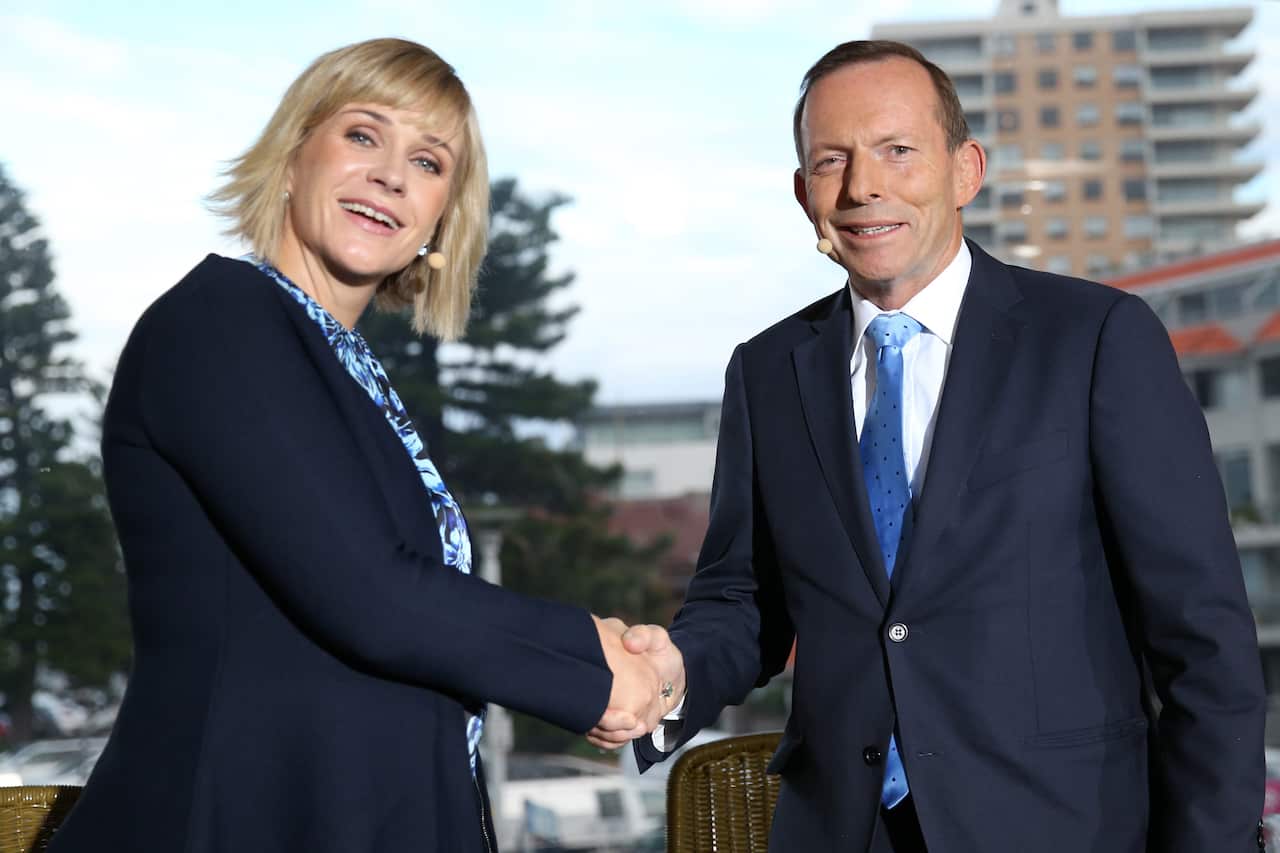 Warringah candidates Zali Steggall and Tony Abbott shake hands ahead of their debate at Queenscliff Surf Club.