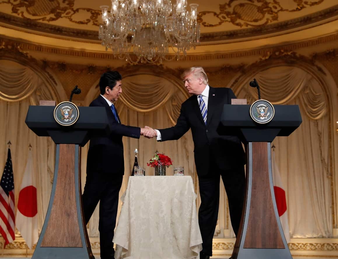President Donald Trump and Japanese Prime Minister Shinzo Abe shake hands during a news conference at Trump's private Mar-a-Lago club
