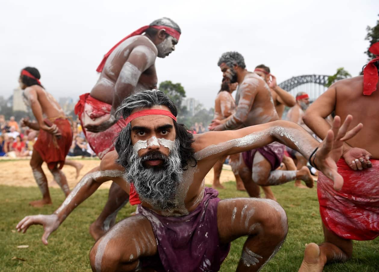 A group of Aboriginal people in traditional dress dance in Sydney