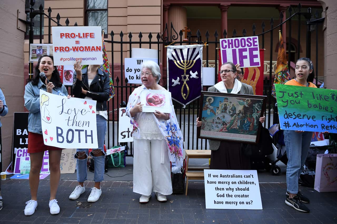 Advocates hold placards during a rally outside the New South Wales Parliament. More rallies are expected ahead of the final vote. 