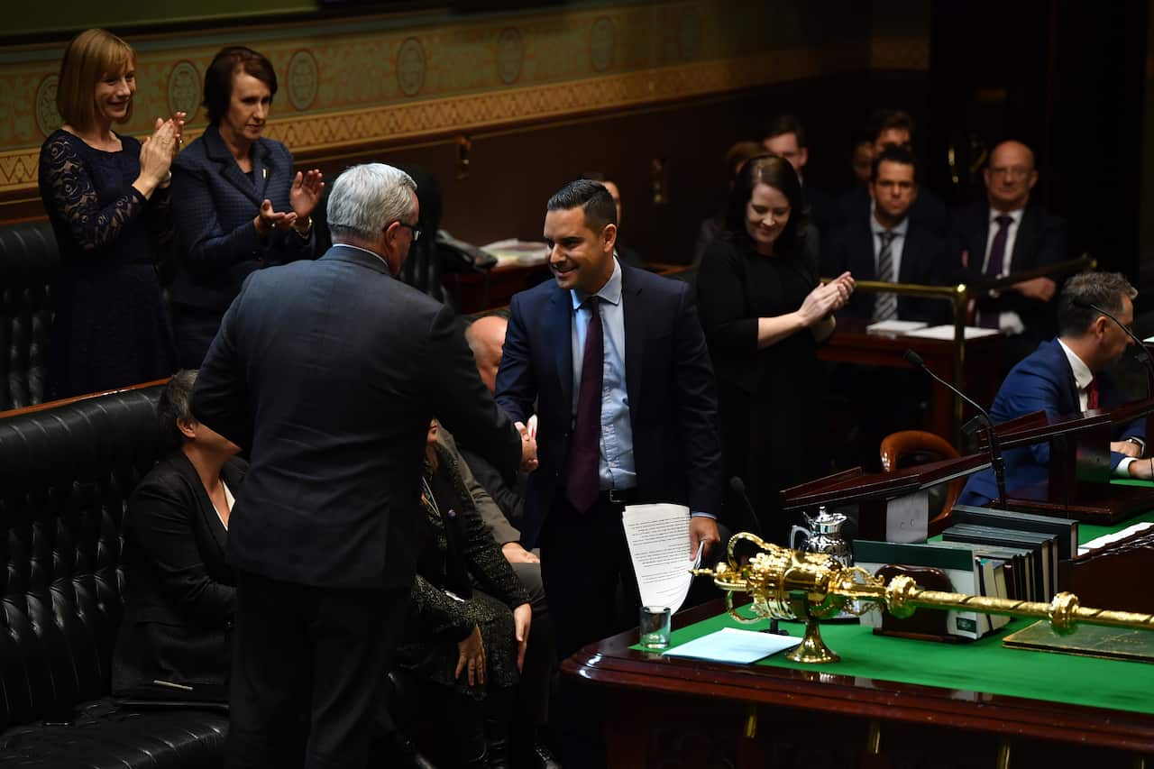 NSW Minister for Health and Medical Research Brad Hazzard congratulates NSW Member for Sydney Alex Greenwich as he introduces the Reproductive Healthcare bill.
