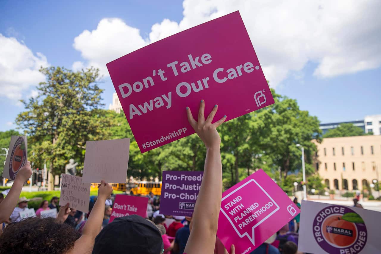 Protesters rally outside of the Georgia State Capitol building.