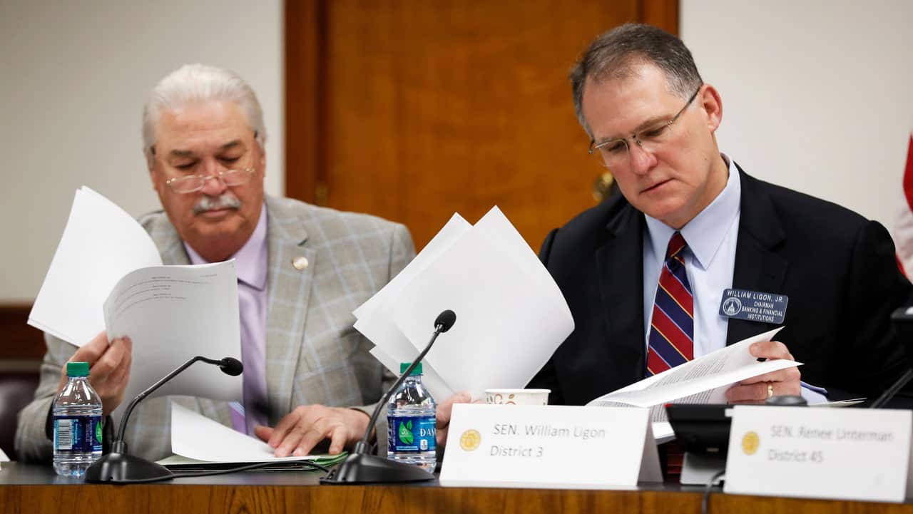 Senator Lee Anderson, left, and Senator William Ligon, Jr, look over proposed amendments to an abortion bill.