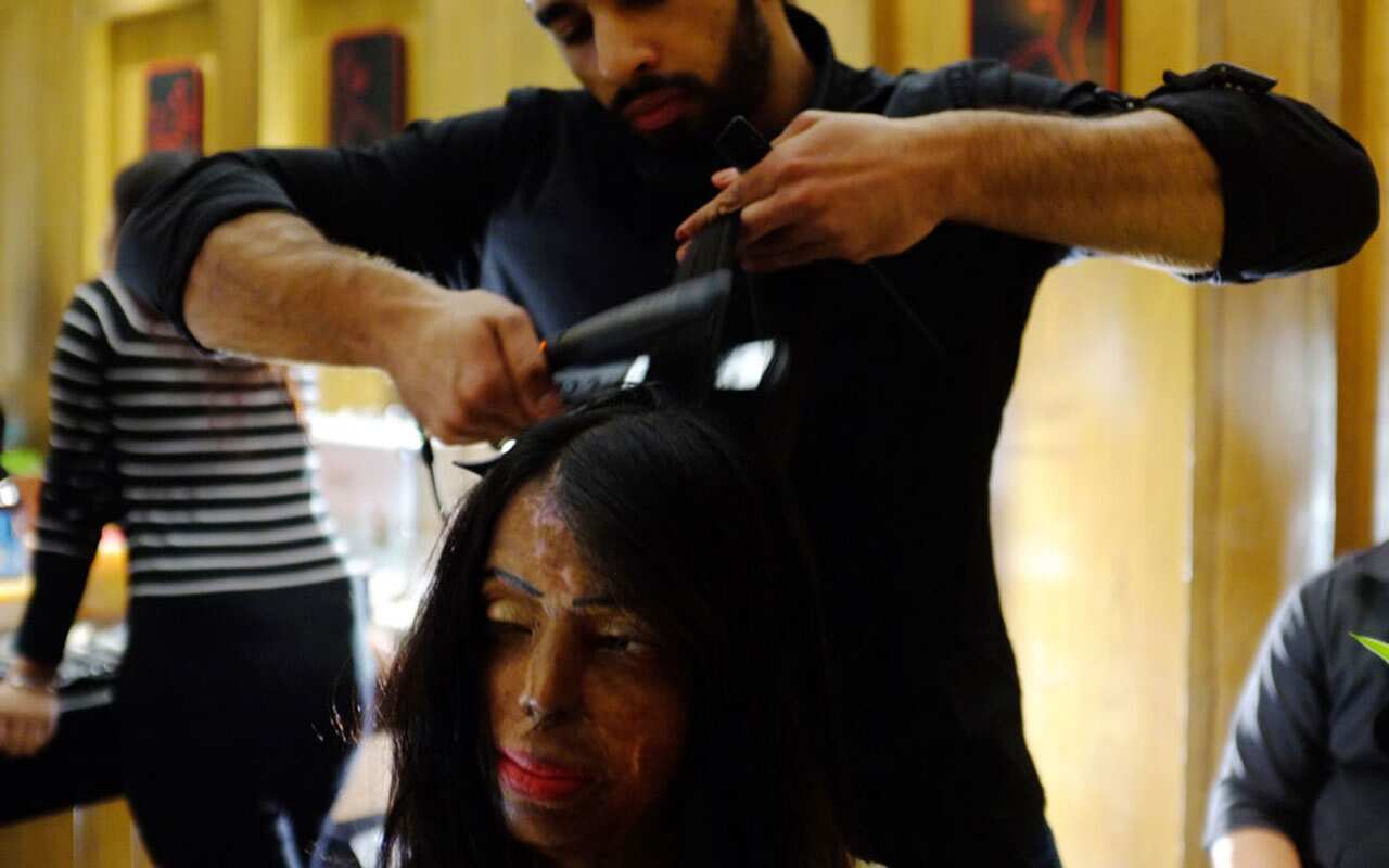 Indian acid attack survivor and model Anupanra has her hair done before a fashion show organised by the 'Make Love Not Scars' NGO.