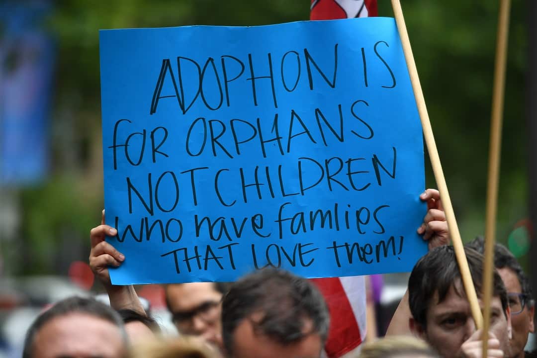 Protesters hold placards at the Stop Forced Adoptions: Reject the Child Protection Bill Protest outside Parliament House in Sydney, Wednesday, November 14, 2018. (AAP Image/Joel Carrett) NO ARCHIVING
