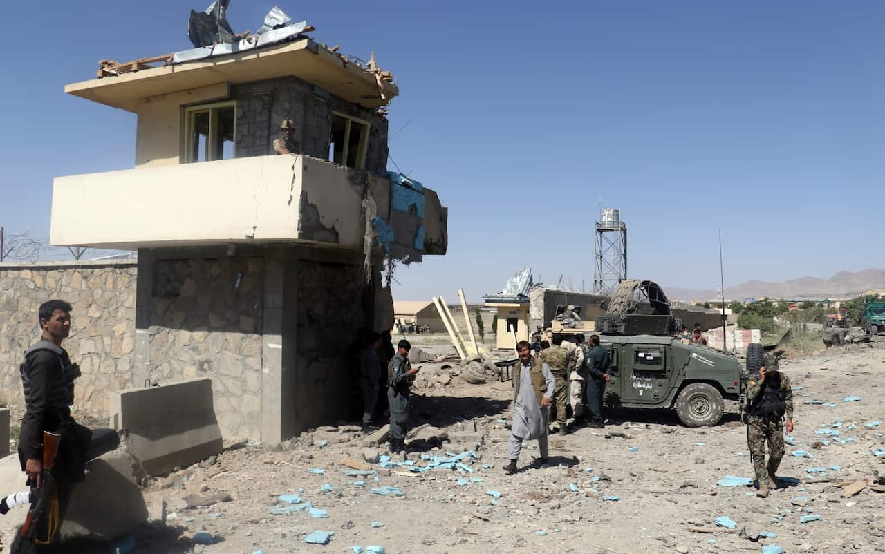 Security forces are deployed as the site of suicide attacks and an ongoing clash between Taliban insurgents and government forces (AAP)