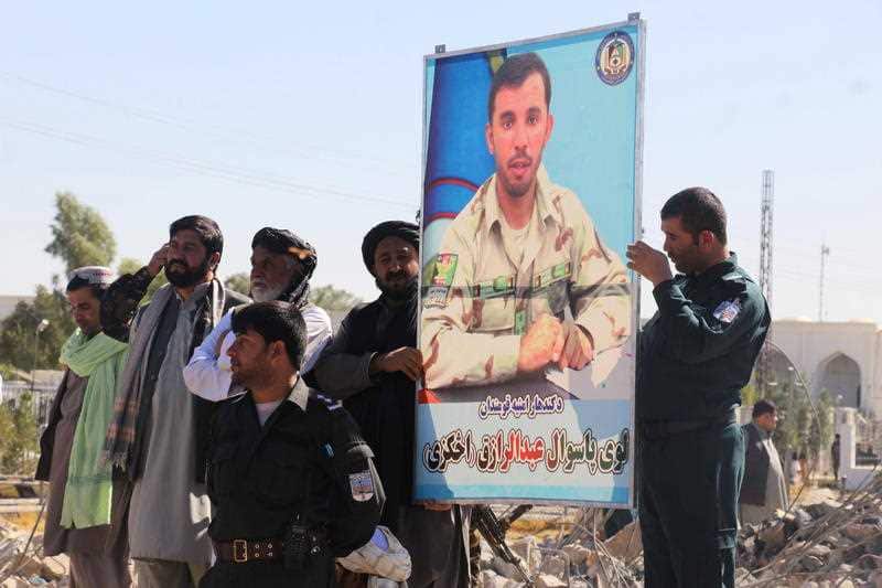 Afghan officials attend the burial of Police Commander General Abdul Razzaq Dawood, in Kandahar, Afghanistan.