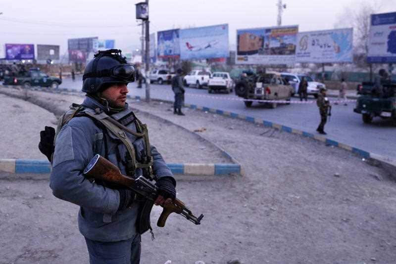 Afghan security forces stand guard following the attack.