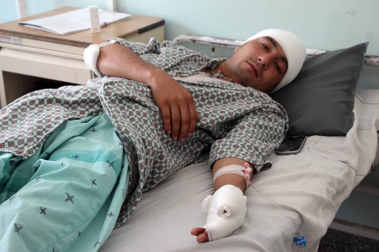A man who was injured in a bomb explosion outside a polling station, receives medical treatment at a hospital in Kandahar.