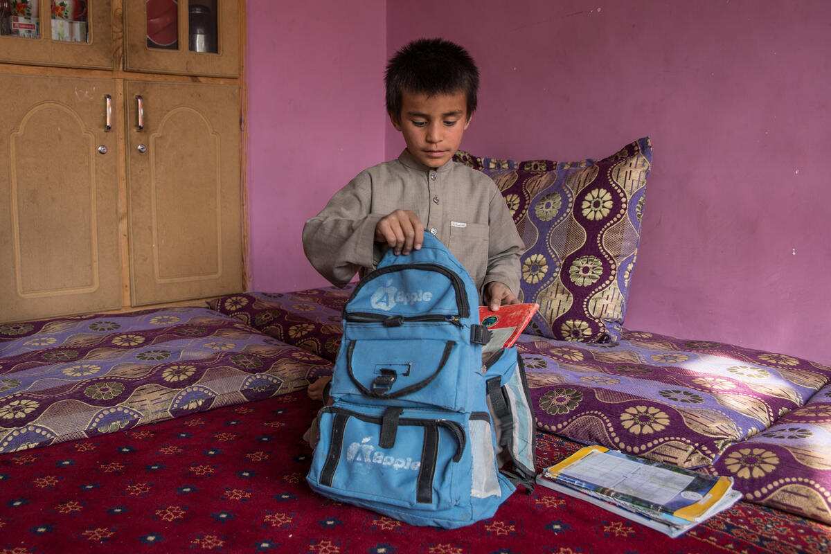 The boy packs up his back ahead of another trek through Kabul to school. 