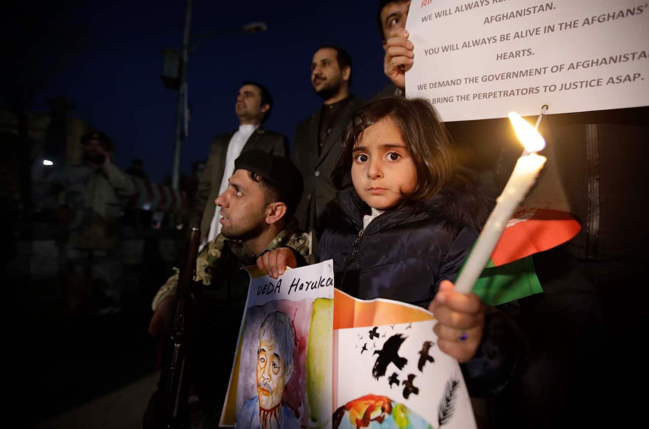 Afghan people light candles for Japanese doctor Tetsu Nakamura during a memorial service. 