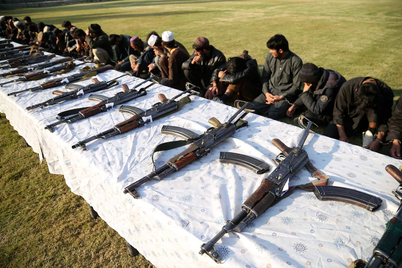 Former militants surrender their weapons during a reconciliation ceremony in Jalalabad, as part of ongoing peace dealings.
