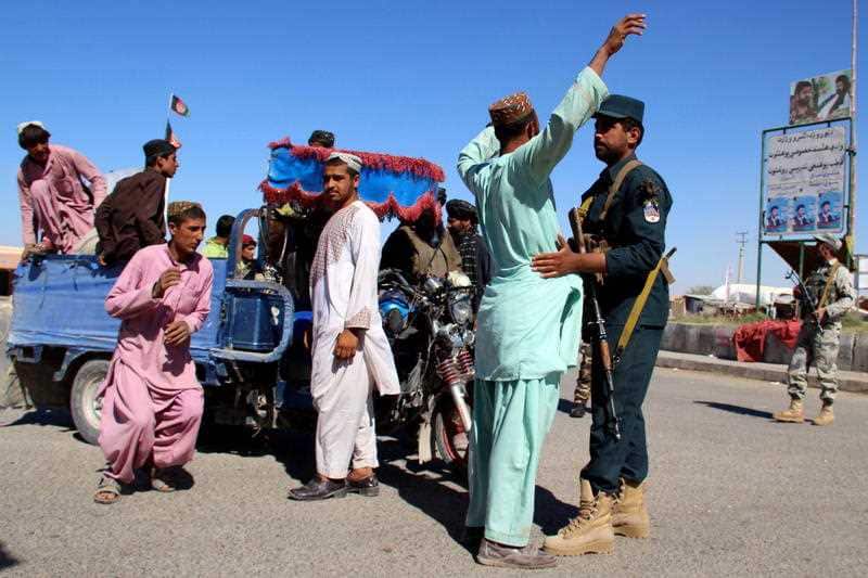 Afghan security officials check people and vehicles  as security has been intensified ahead of parliamentary elections in Helmand.
