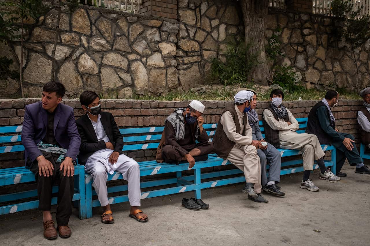 Azizullah, center, waiting before being allowed to pick up his wife and newborn baby in Kabul, Afghanistan, on Wednesday, May 13, 2020. (Jim Huylebroek/The New York Times)