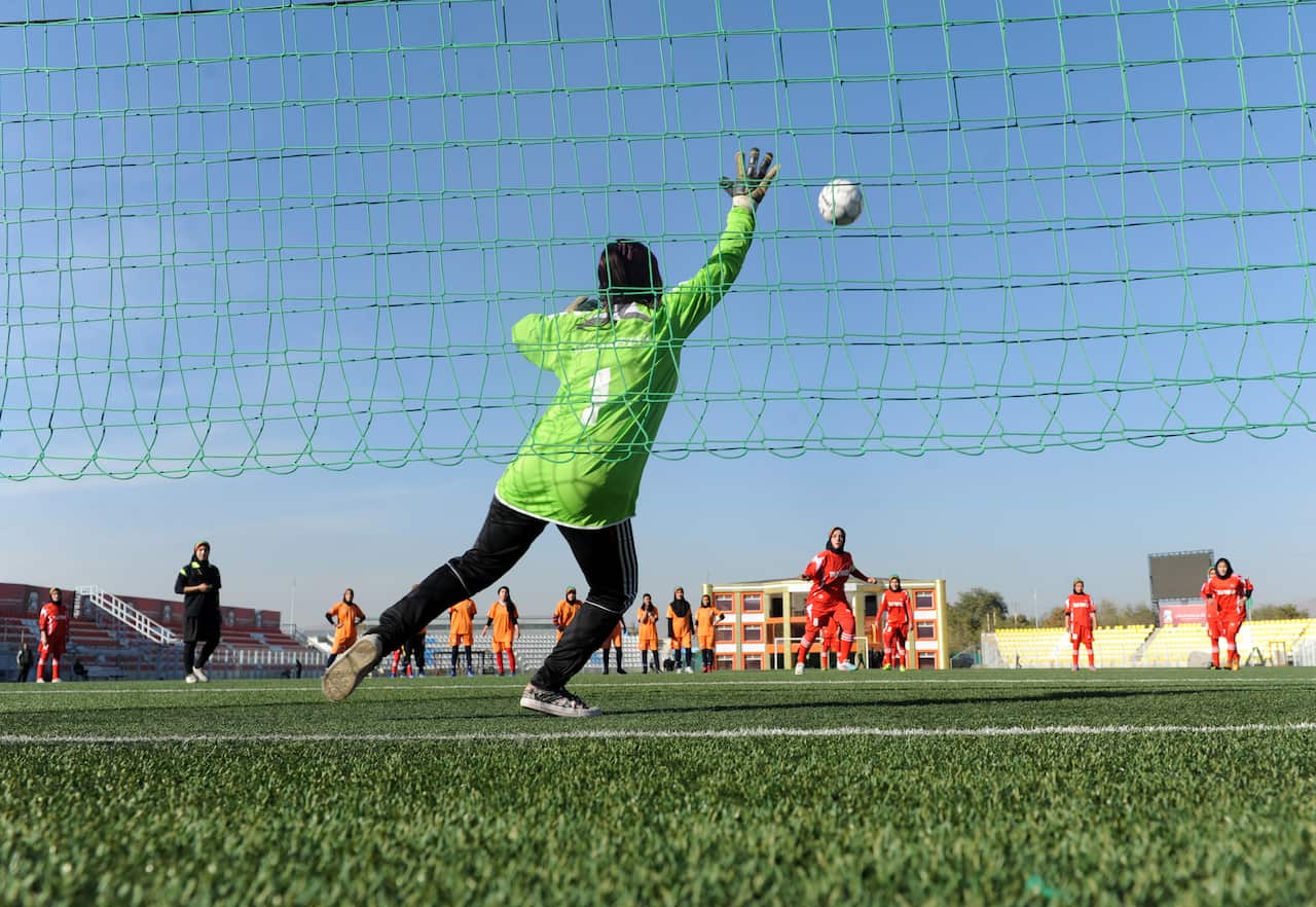 An Afghan female football player shoots a penalty during a football match in Kabul (Getty/AFP)