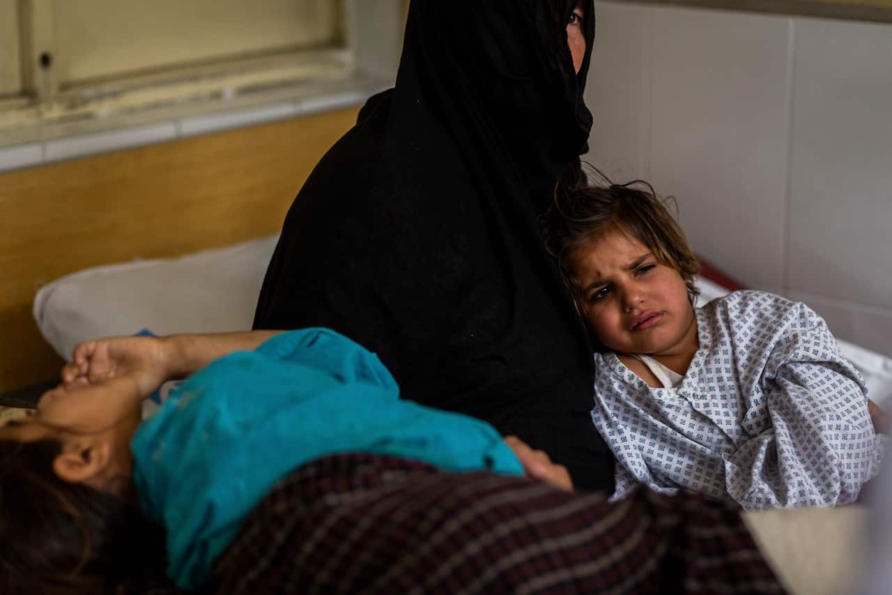 Lol Pora comforts her nieces Rabia, 7, and Marwa, 4, at Nangarhar Regional Hospital in Jalalabad, Afghanistan.