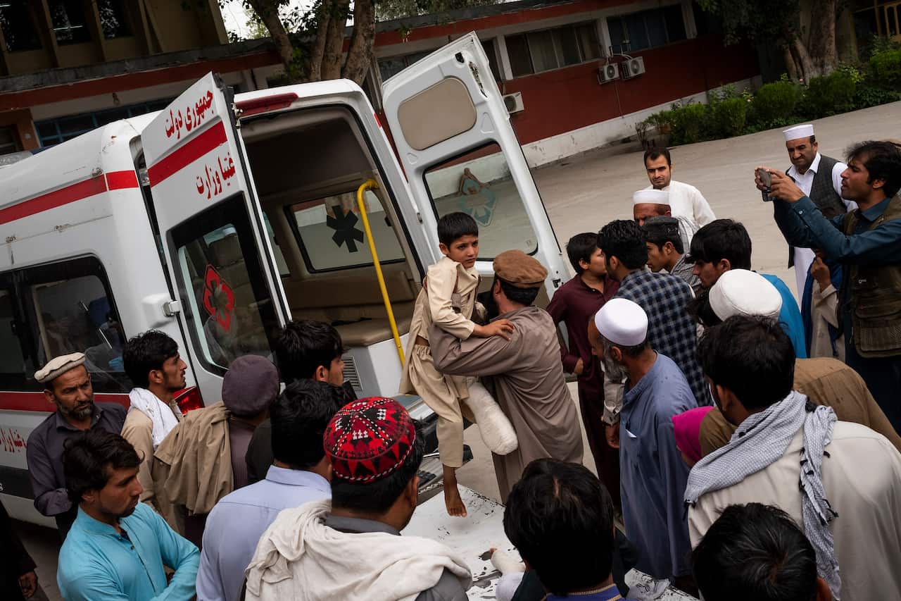Bashir, 12, is brought to an ambulance that will take him and his brother, Aman, 5, home, at Nangarhar Regional Hospital in Jalalabad, Afghanistan.