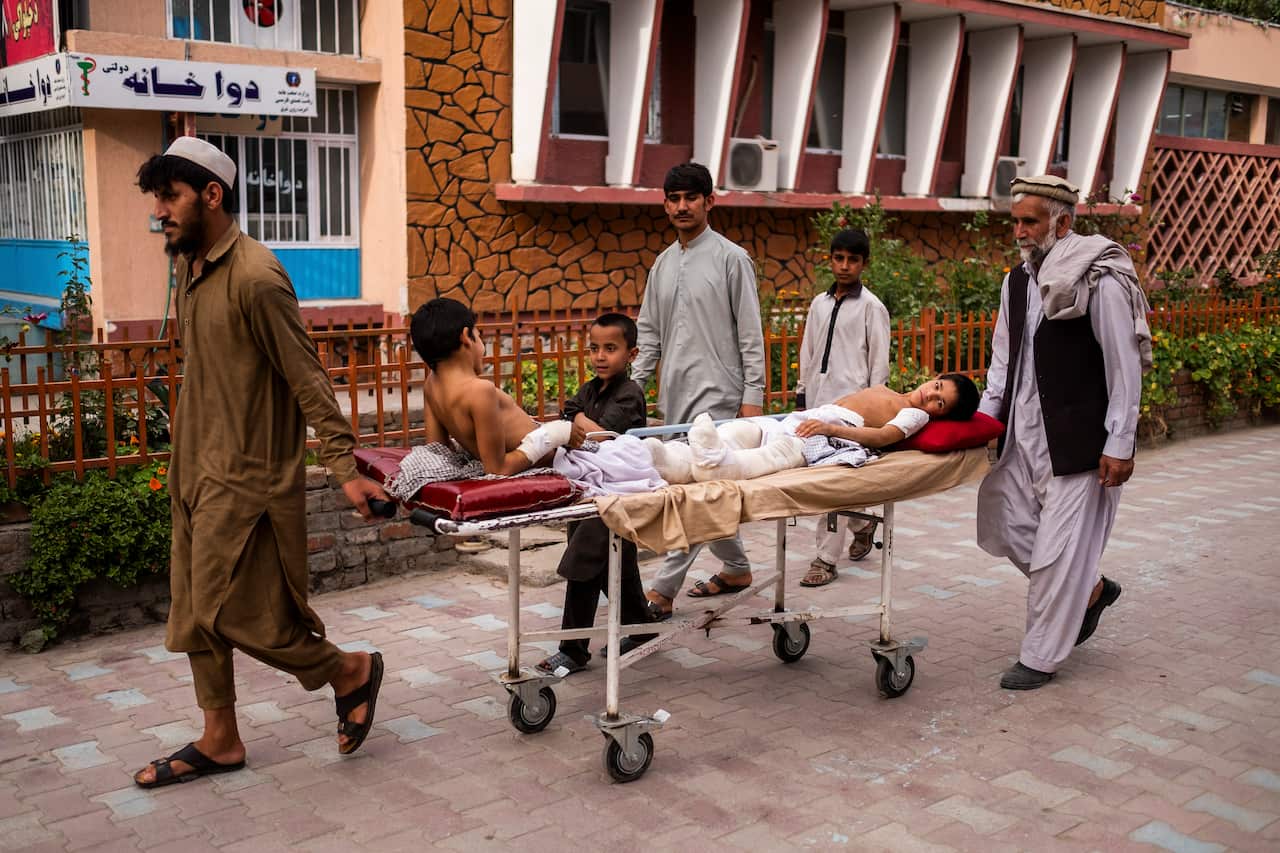 Lol Pora comforts her nieces Rabia, 7, and Marwa, 4, at Nangarhar Regional Hospital in Jalalabad, Afghanistan.
