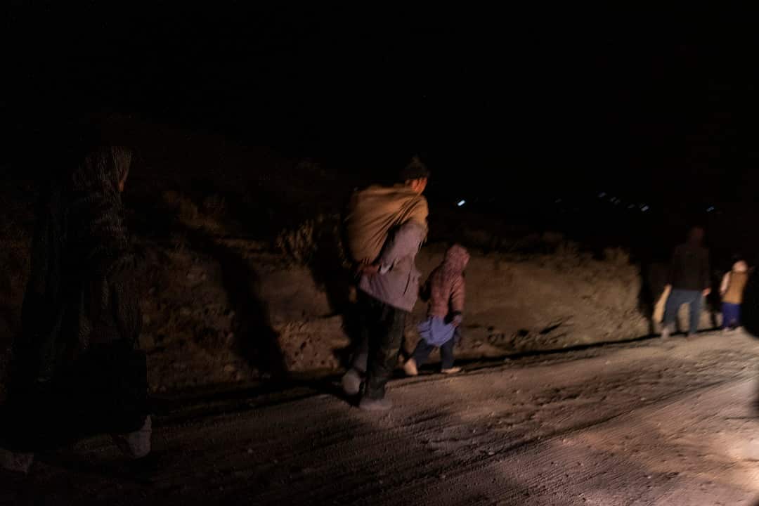 Residents flee the area in the dark of night in the district of Jaghori, Afghanistan.