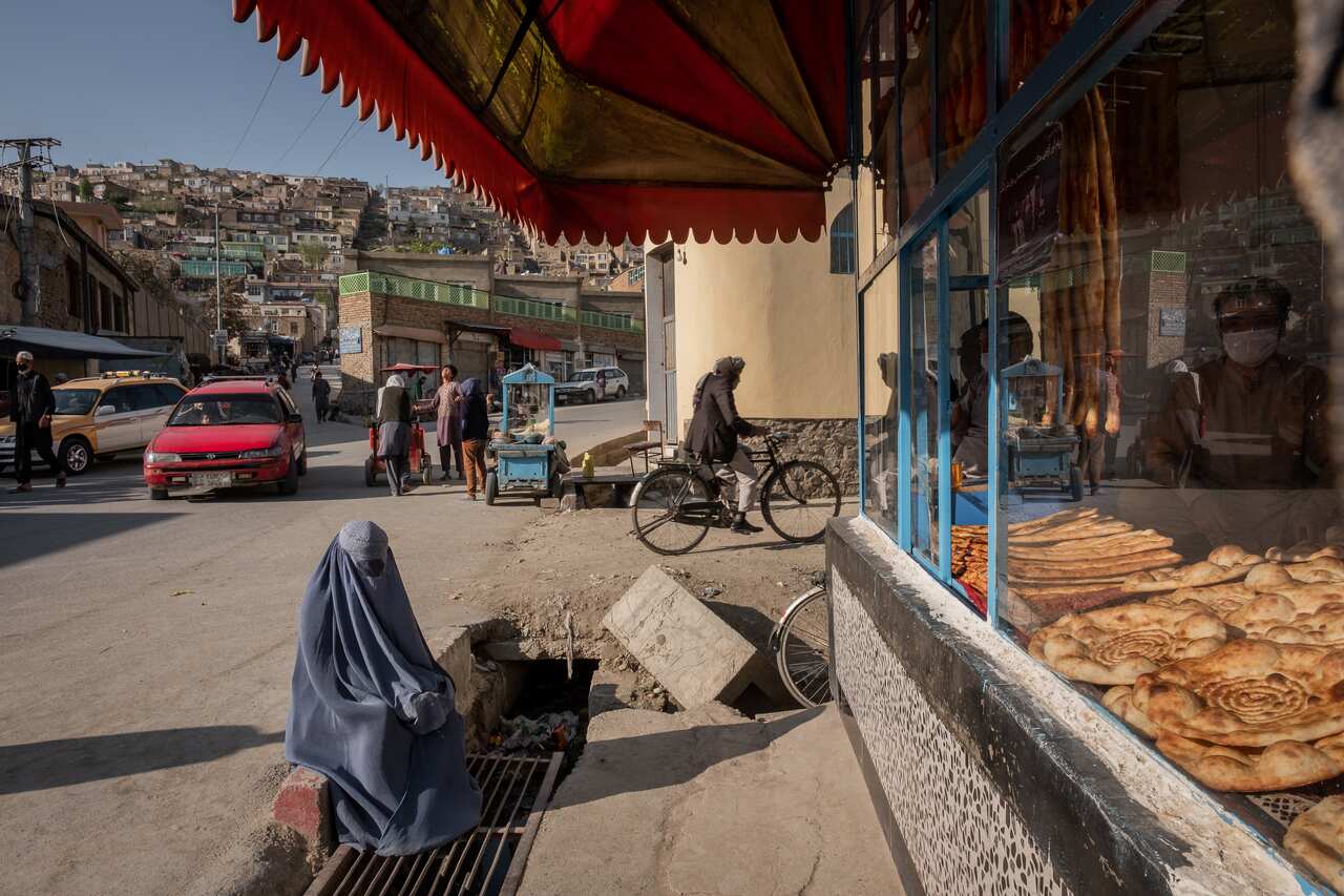 A file photo of a woman begging in front of a bakery in Kabul, Afghanistan, 23 April, 2020. 