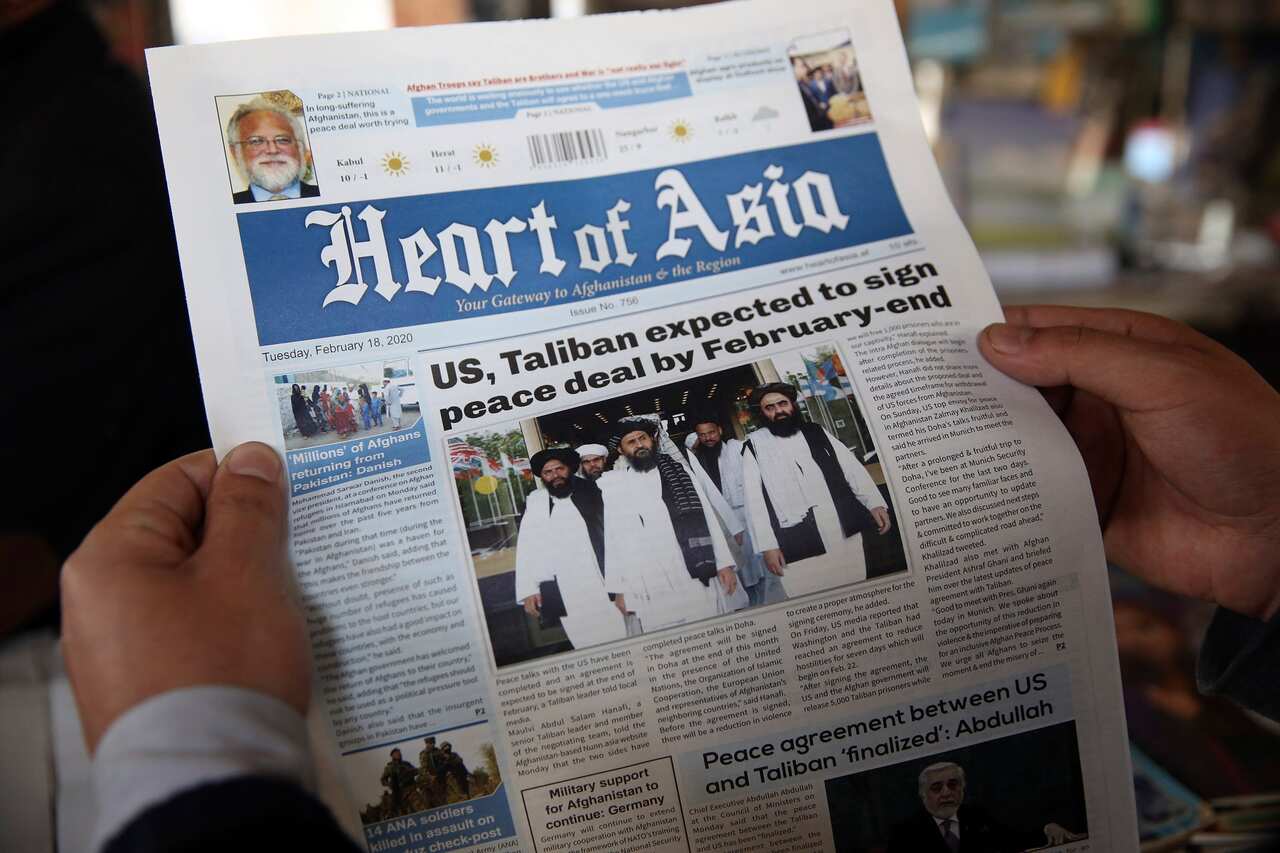 A man reads a local newspaper about peace in Kabul, Afghanistan.