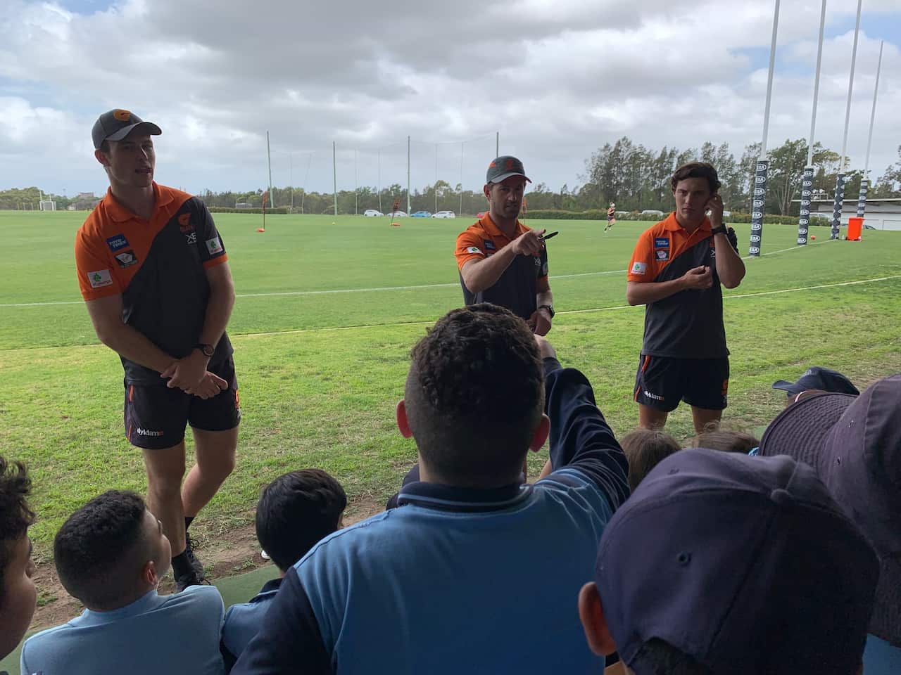 Giants players Callan Ward, Kieran Briggs and Jye Caldwell, left to right, with Greenacre School students (SBS)