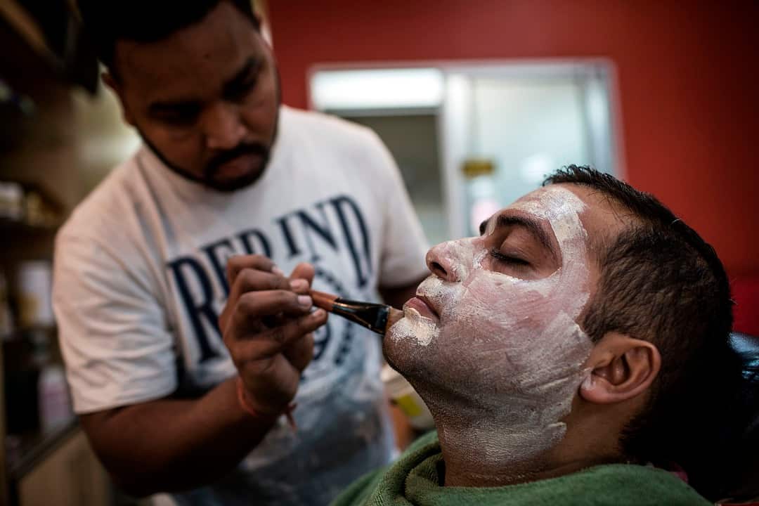 Aasif Khalifa in Johannesburg applies a mask as part of a facial which uses skin lightening products.