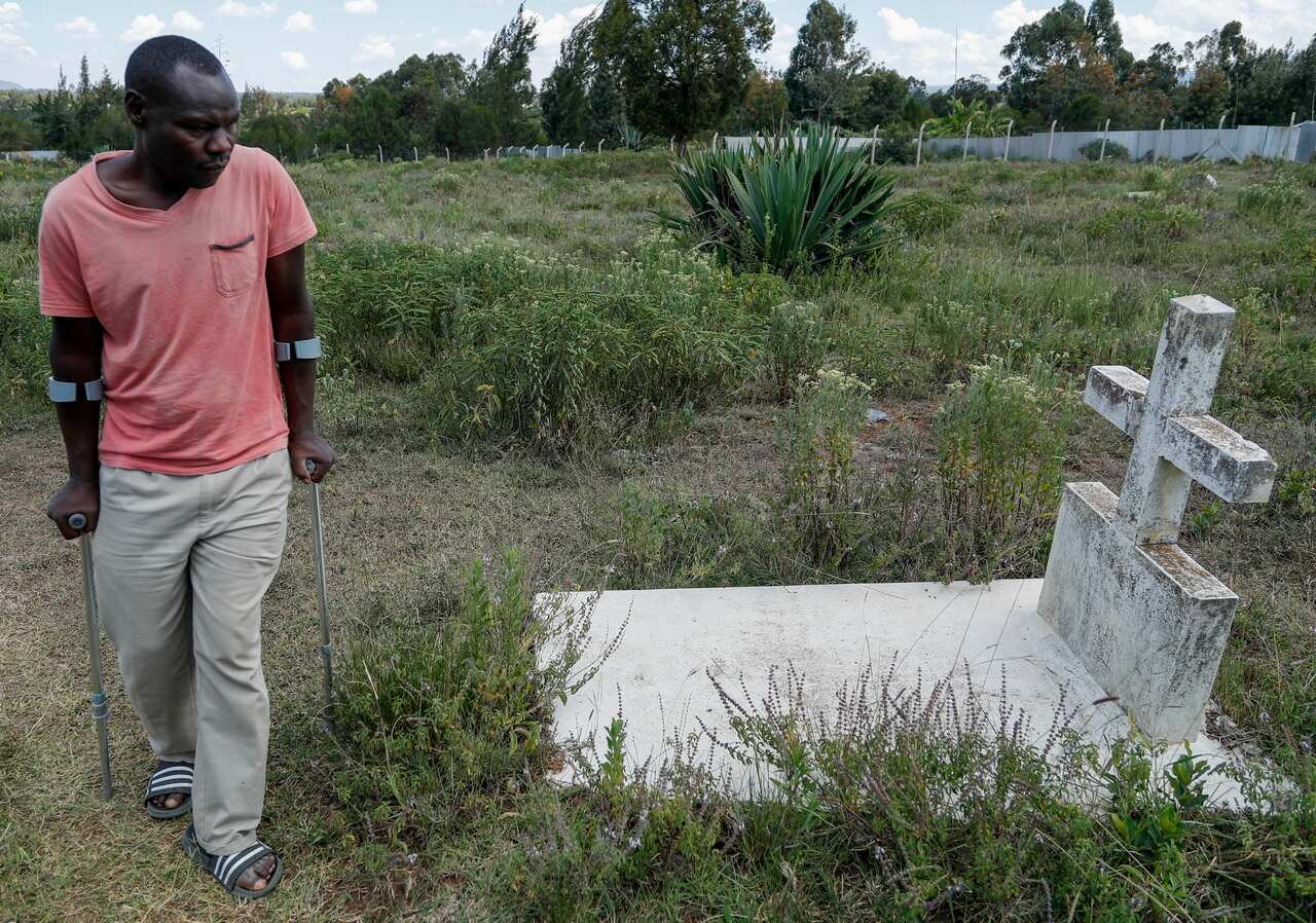 John Muchiri Kamunge, brother-in-law to Agnes Wanjiru, 20, visits her grave at a cemetery in Nanyuki, Kenya Thursday, Nov. 4, 2021. 