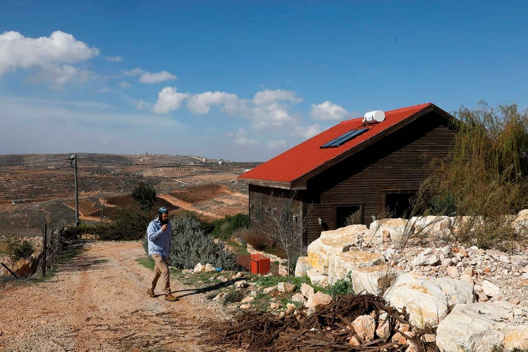 Nati Rom, who is campaigning against the Palestnian-led boycott movement, walks next to an Airbnb apartment located in the occupied West Bank.