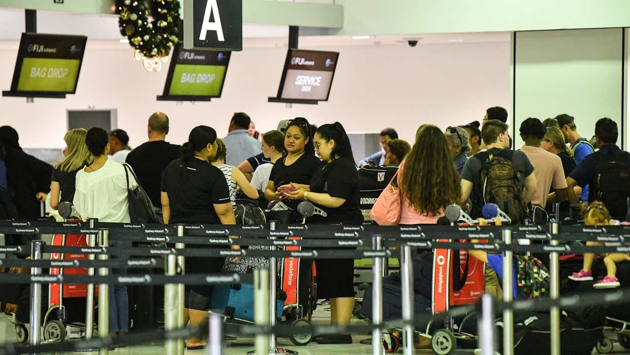 Travellers are seen queueing Overseas Arrivals and Departures at Sydney's International Airport in Sydney on 17/12/18,