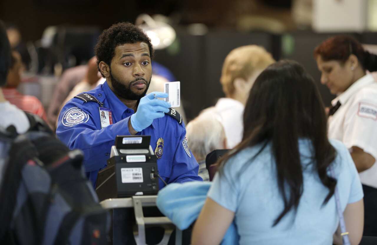 A Transportation Security Administration employee works at a security check point at LaGuardia Airport in New York, May 2016. 