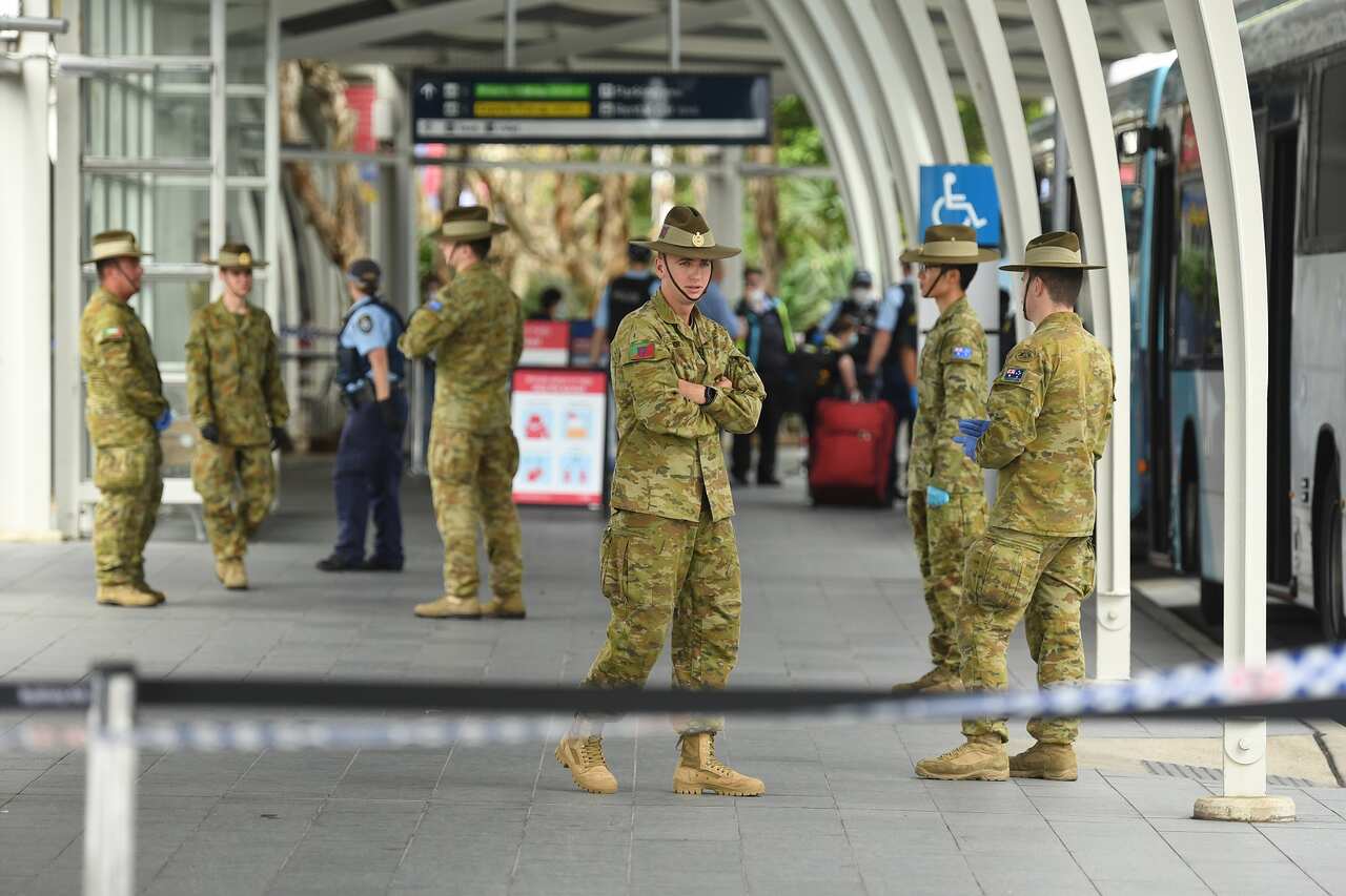 Army enforce a mandatory 14-day quarantine for returning overseas travellers at Sydney International Airport.