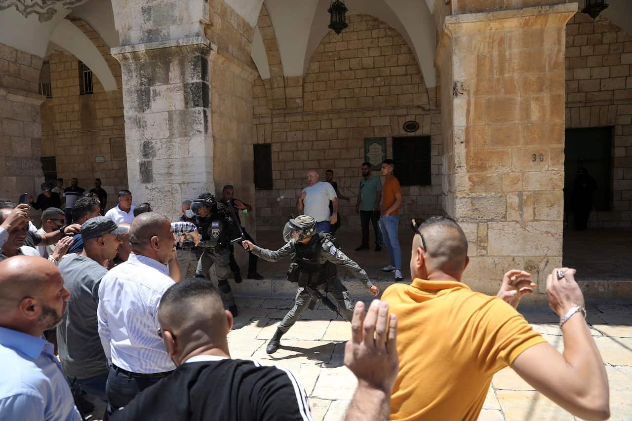 A confrontation between Israeli border police and Muslim worshippers gathered for Friday prayers at Al-Aqsa Mosque on 14 May 2021. 