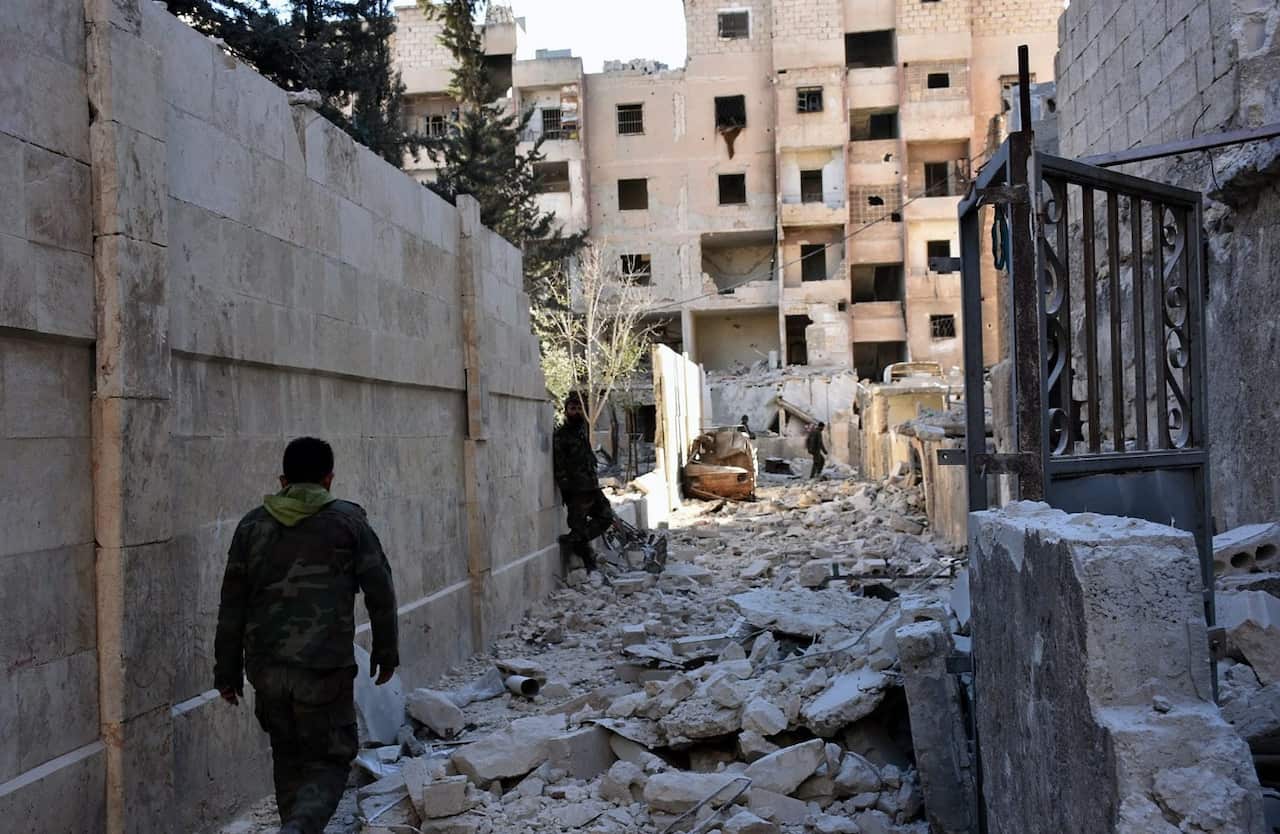 A handout picture made available by the official Syrian Arab News Agency (SANA) shows Syrian soldiers in Aleppo's eastern Masaken Hanano area in Aleppo province, 