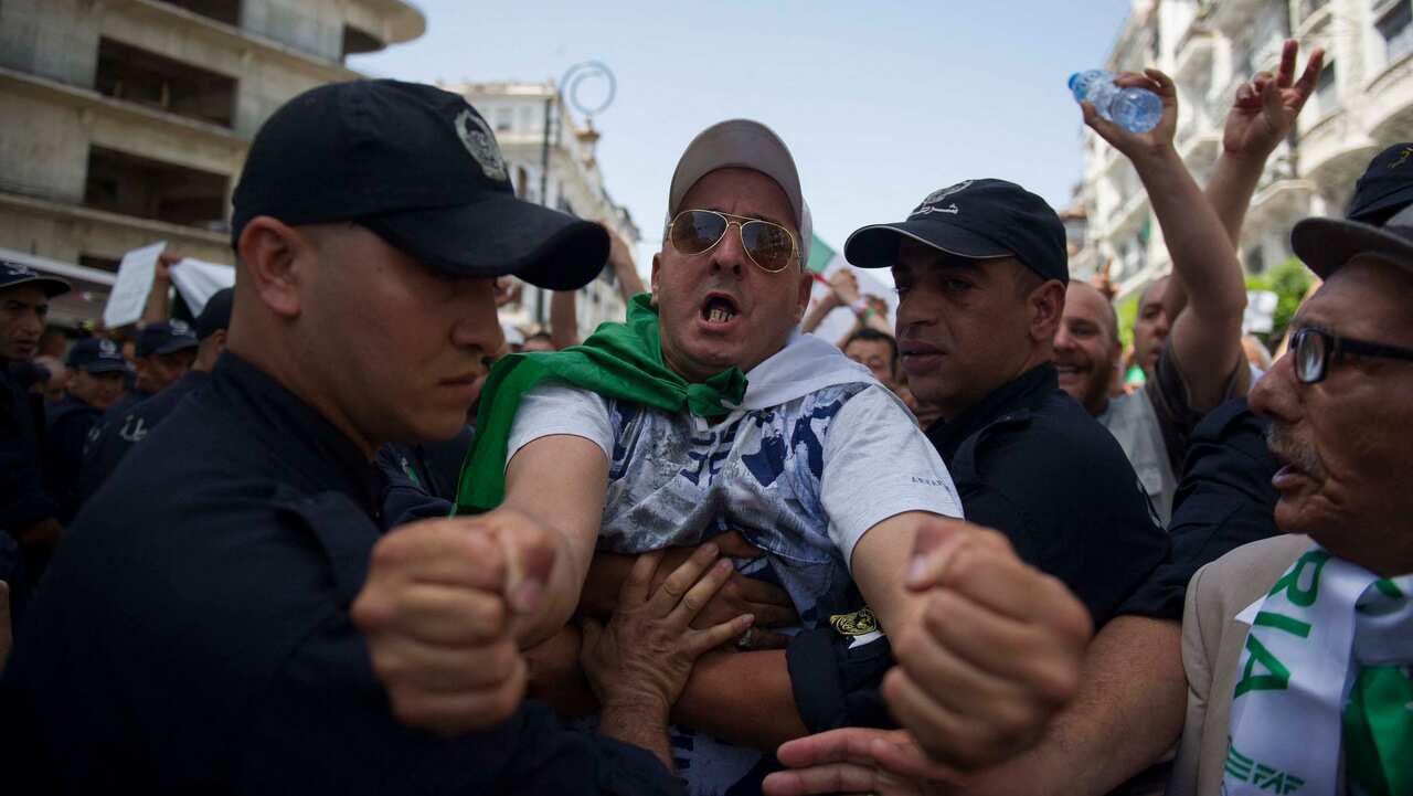 Algerian protesters clash with members of the security forces during the weekly protest Friday in the capital, Algiers on June 21 2019. 