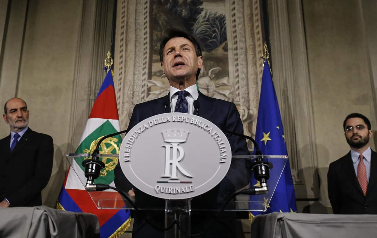 Italian Prime Minister-designate Giuseppe Conte (R) addresses the media to announce his list of ministers 