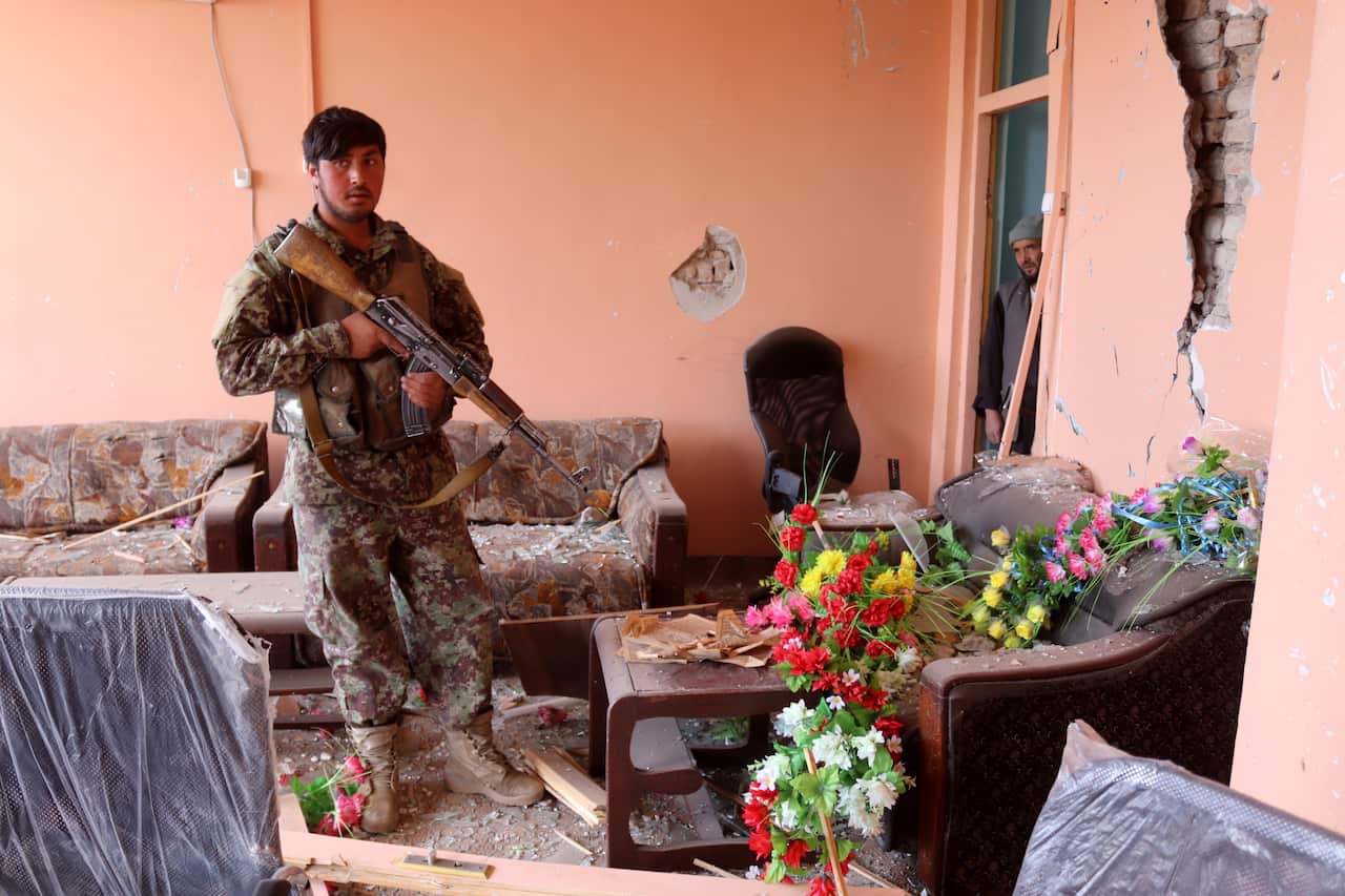 An Afghan Army soldier at the scene of a truck bomb blast (AAP)