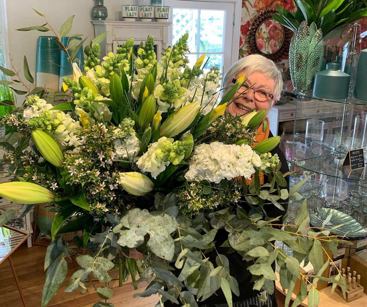 Florist Anja Seebus behind a large floral arrangement