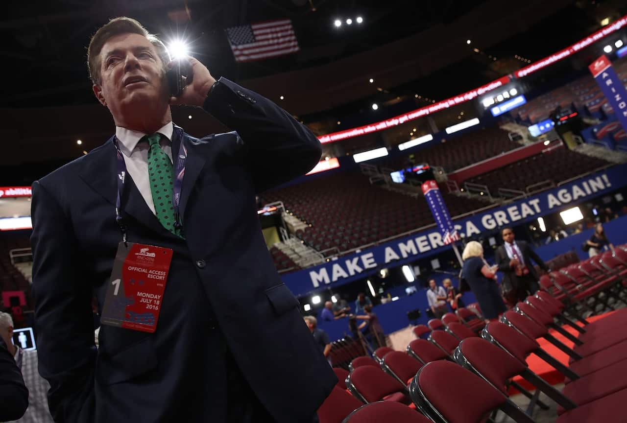 Paul Manafort, Campaign Manager for Donald Trump, speaks on the phone while touring the floor of the Republican National Convention in July 2017 