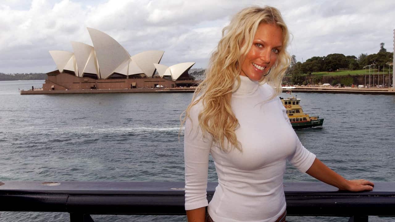 Annalise Braakensiek having her photo taken with the Sydney Opera House in the background in 2004.