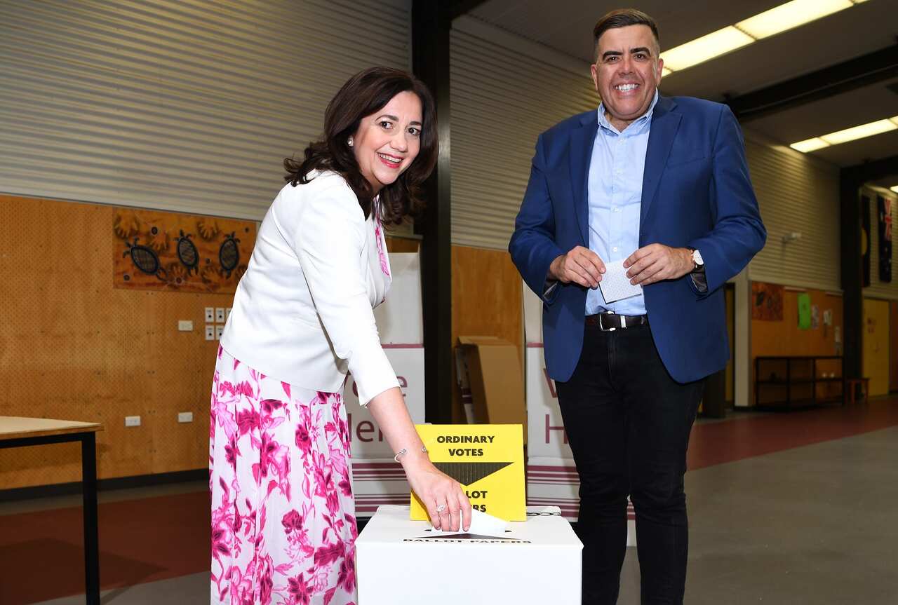 Queensland Premier Annastacia Palaszczuk, joined by the Member for Oxley Milton Dick, casts her vote in the state election.