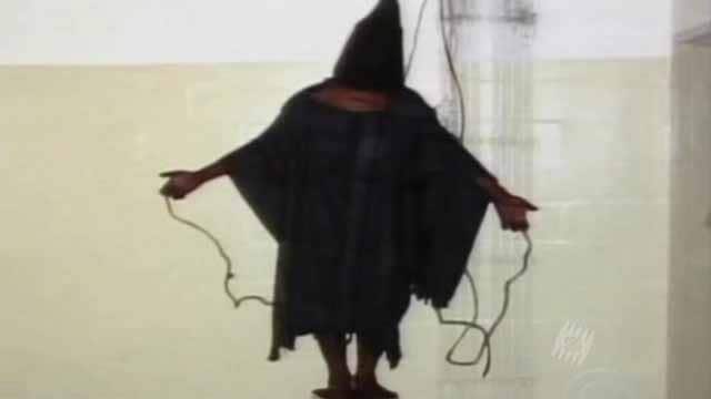 A hooded man with his arms outstretched