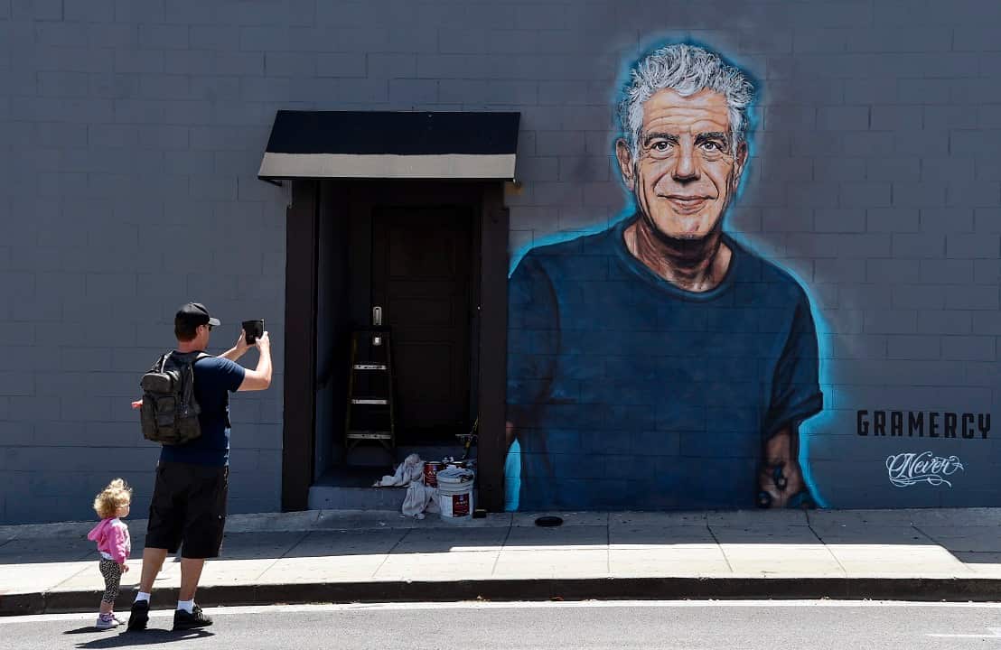 A mural of Anthony Bourdain by artist Jonas Never on the side of a wall of new restaurant Gramercy in California.